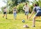 Teenagers play street football with excitement in park