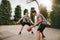 Teenagers playing basketball on outdoor court