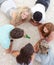 Teenagers playing spin the bottle on the floor