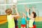 Teenagers playing volleyball in school gymnasium