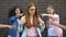 Teenagers pointing fingers teasing new smart classmate in eyeglasses school bag