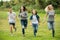 Teenagers running on green lawn in park