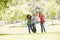 Teenagers Running Through Park