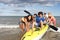 Teenagers in sea with canoe