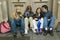 Teenagers sitting in doorway after school, Paris, France