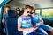 Teenagers with smartphone inside an old campervan, roadtrip