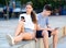 Teenagers with smartphones are siting on the step