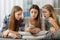 Teenagers staring surprised at mobile phone