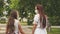 Teenagers on street of city travel in a medical mask. two girls in protective masks walk on their faces outdoors in park