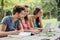 Teenagers studying outdoors