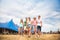 Teenagers at summer music festival in front of big blue tent