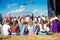 Teenagers, summer music festival, sitting in front of stage