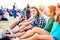 Teenagers at summer music festival, sitting on the ground