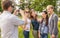 Teenagers taking photo digital camera outside