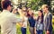 Teenagers taking photo with digital camera outside