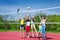 Teenagers team actively playing volleyball game