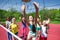 Teenagers team playing volleyball on the court