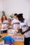 Teenagers in white t-shirts sorting glass and plastic together