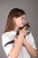 Teengirl holding a baby cat on gray background. Portrait of young girl with kitten. Kids and pets