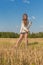 Teengirl with a scythe at summer field