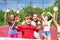 Teens with arms up play volleyball near the net