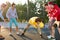 Teens boys playing basketball on outdoor court, playground and having fun