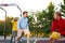 Teens boys playing basketball on outdoor court, playground and having fun