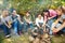 Teens on campsite grill sausages sitting near tent