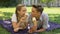 Teens fooling around, eating ice-cream in park on plaid, kissing each other