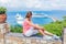 Teens girl looking at a cruise ship in the lagoon Mediterranean Sea, Greece
