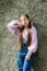 Teens girl posing against gray street wall