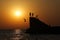 Teens jump from the pier into the sea.