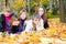 Teens lying on autumnal leaves