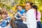 Teens with marshmallow sticks sitting near bonfire