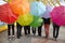 Teens with opened umbrellas in pedestrian overpass