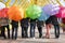 Teens with opened umbrellas. rainbow concept