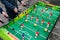 Teens play table football in the street. A game of table football. Young people playing board game outdoors in the summer