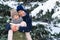 Teens portrait in a winter forest, boy and girl, beautiful nature with bright snowy fir trees