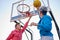 Teens shooting basket and playing basketball, lower view wide angle