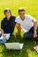 Teens sitting in park with laptop students