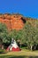 Teepee by trees and red rocks