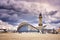 Teepott and lighthouse under dramatic clouds in WarnemÃ¼nde