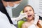 Teeth checkup at dentist\'s office. Dentist examining girls teeth