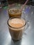 Teh tarik or pulled tea is a famous sweet milk tea in Malaysia. Bubble is floating on the surface of teh tarik