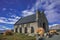 Tekapo, New Zealand. Old stone church with mountain and blue sky background