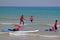 Tel-Aviv, Israel - 04/05/2017: Children catch a wave. Children`s school of surfing on Mediterranean Sea.
