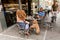 Tel Aviv, Israel - September 9, 2011: People with their dog are relaxing in cafe on the street located near the beach Tel Baruch