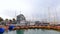 Tel Aviv-Yafo, Israel - December 29, 2021: Panning shot of Jaffa old city harbor with boats, people, and buildings. High