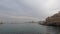 Tel Aviv-Yafo, Israel - December 29, 2021: Panning shot of Jaffa old city harbor with boats, people, and buildings. High