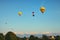 TELC, THE CZECH REPUBLIC-AUGUST 25, 2017: Group flight of hot balloons at sunset over city Telc